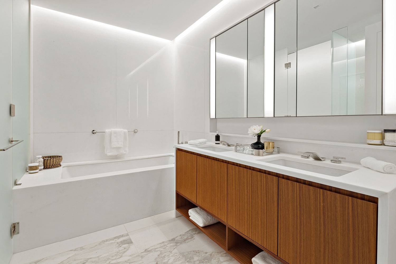 1289 Lexington spacious bathroom with private shower, powder room, and his and her sinks.